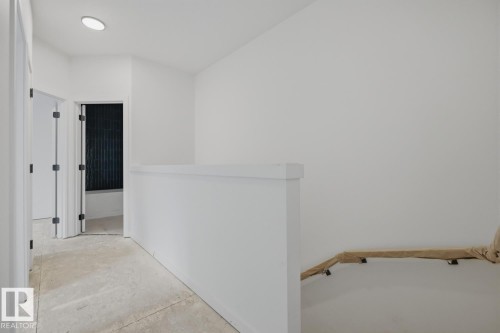 Upper-level hallway featuring a clean aesthetic with white walls and ceiling - 11327 122 Street, Edmonton, AB - Indoor Photo Showing Other Room