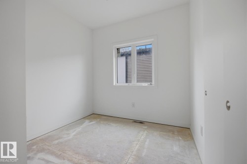 Room featuring white painted walls and a single window with white trim - 11327 122 Street, Edmonton, AB - Indoor Photo Showing Other Room