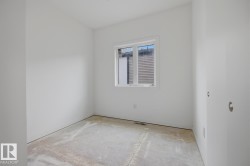 Room featuring white painted walls and a single window with white trim - 