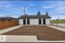 Detached structure featuring white siding, a dark shingle roof, and two black exterior doors - 11327 122 Street, Edmonton, AB  - Outdoor 