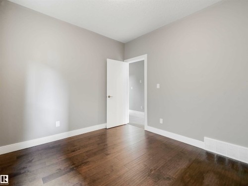 Room with light gray walls and wood-finish flooring - 1090 Armitage Crescent, Edmonton, AB 