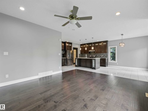 Open-concept interior featuring wood-finish flooring, recessed lighting, and a ceiling fan - 1090 Armitage Crescent, Edmonton, AB 