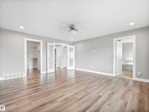 Spacious room featuring light wood-finish flooring, recessed lighting, and a ceiling fan - 1090 Armitage Crescent, Edmonton, AB 
