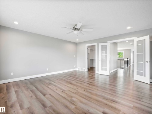 Spacious room featuring light wood-finish flooring, recessed lighting, and a ceiling fan - 1090 Armitage Crescent, Edmonton, AB 