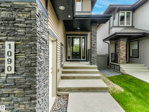 Modern exterior featuring horizontal siding and stacked stone accents - 1090 Armitage Crescent, Edmonton, AB 