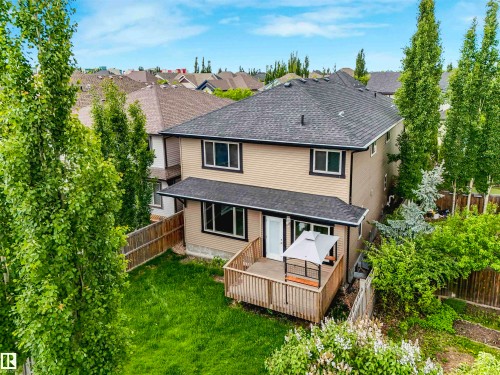 Two-story residence with light-colored siding and a dark shingled roof - 1090 Armitage Crescent, Edmonton, AB 