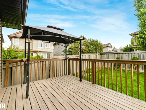 Expansive wood deck with a built-in gazebo frame, providing an outdoor living area - 1090 Armitage Crescent, Edmonton, AB 