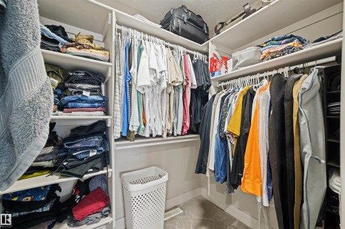 Custom closet organization system featuring white shelving and hanging rods - 12171 177 Avenue, Edmonton, AB 