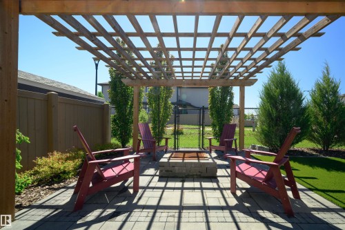 Expansive outdoor patio featuring a wood pergola and a built-in fire pit - 12171 177 Avenue, Edmonton, AB 