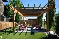 Outdoor pergola with a paver patio and built-in fire pit - 