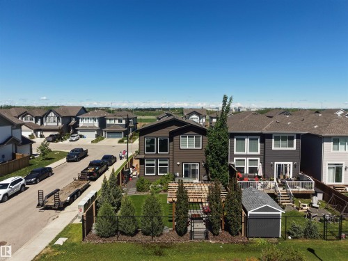 Modern two-story residence featuring a dark brown exterior with white trim windows and a fenced backyard - 12171 177 Avenue, Edmonton, AB 