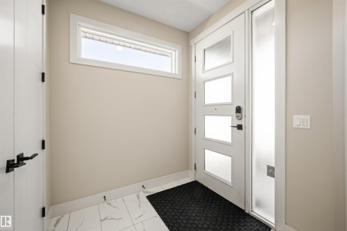 Modern entry door with frosted panels, sidelight, and smart lock hardware - 12171 177 Avenue, Edmonton, AB 