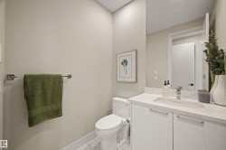 Contemporary bathroom featuring a white vanity with integrated sink, chrome faucet, and mirrored cabinet - 