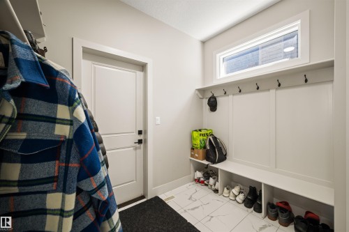 Entryway featuring a built-in bench, upper shelf, and coat hooks - 12171 177 Avenue, Edmonton, AB 