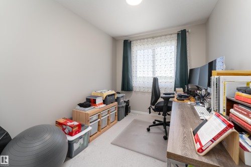 Room featuring a window with sheer and blackout curtains, light-colored walls, and carpeting - 2520 152 Avenue, Edmonton, AB 