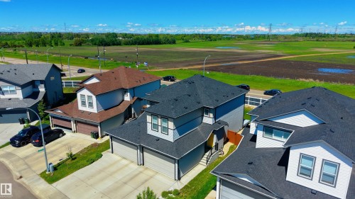Modern two-story home featuring a grey exterior with white trim, a dark shingle roof, and an integrated two-car garage - 2520 152 Avenue, Edmonton, AB 
