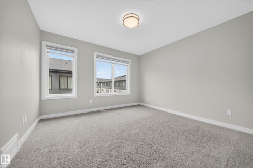 Spacious room with light gray walls and plush gray carpeting - 52 1729 Keene Crescent, Edmonton, AB 