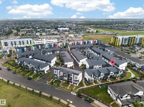 Aerial perspective highlighting a modern townhome community with varied architectural facades and dark rooflines - 52 1729 Keene Crescent, Edmonton, AB 