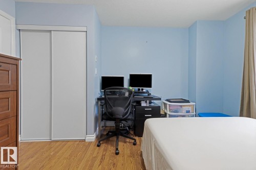 Room featuring wood-finish flooring and light blue walls - 211 1204 156 Street Nw, Edmonton, AB 