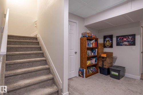 Carpeted staircase with white handrail and trim - 17562 63A Street, Edmonton, AB 