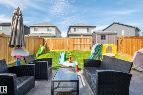 Paved patio area with outdoor seating and a glass-top table - 17562 63A Street, Edmonton, AB 