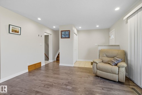 Open-concept living space with wood-finish flooring - 14239 53 Street, Edmonton, AB 