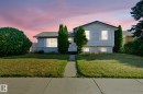 Split-level home featuring light-colored siding and a dark shingle roof - 14239 53 Street, Edmonton, AB 