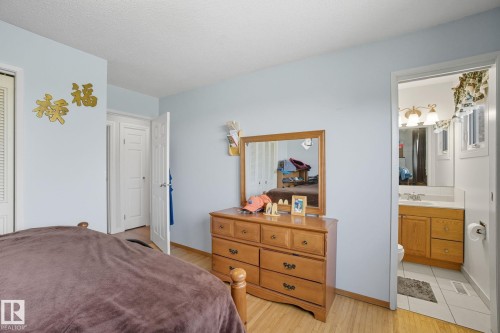 Wood-finish flooring throughout, with light blue wall paint and white trim - 14239 53 Street, Edmonton, AB 