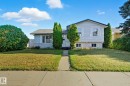Split-level residence featuring light-colored siding and a dark roof - 14239 53 Street, Edmonton, AB 