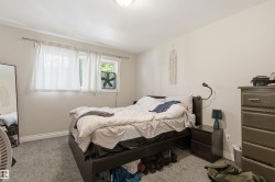 Carpeted bedroom featuring two windows, recessed lighting, and ample wall space - 