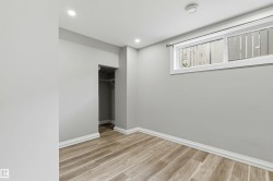 Room featuring wood-finish flooring, recessed lighting, and light grey wall finishes - 