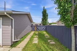 Detached garage with horizontal siding, white trim, and a matching downspout - 
