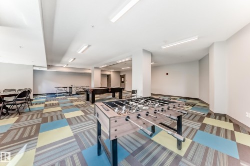 Spacious recreational area featuring a foosball table, billiards table, and ping pong table - 303 560 Griesbach Parade Parade, Edmonton, AB 