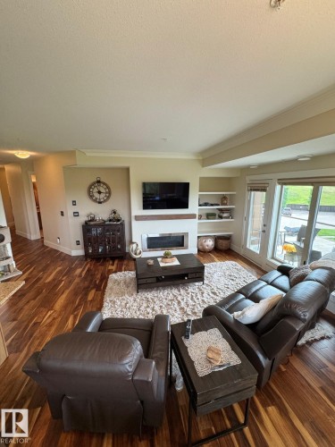 #302 5201 Brougham Dr, Drayton Valley, AB - Indoor Photo Showing Living Room With Fireplace
