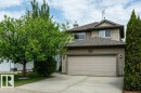Exterior featuring beige horizontal siding, a two-car garage, concrete driveway, and mature landscaping - 8507 2 Avenue, Edmonton, AB  - Outdoor 