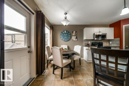 Kitchen and dining area featuring light-toned tile flooring - 8507 2 Avenue, Edmonton, AB - Indoor