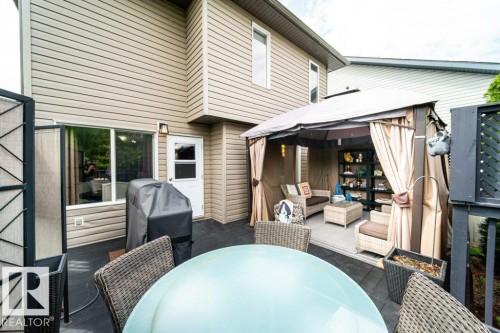 Rear patio featuring dark composite decking - 8507 2 Avenue, Edmonton, AB - Outdoor With Deck Patio Veranda With Exterior