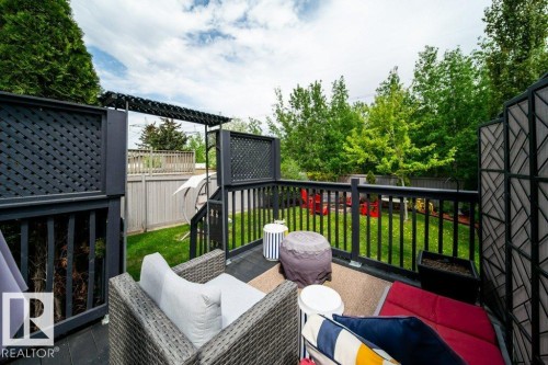 Elevated outdoor deck featuring dark wood-finish decking and railings - 8507 2 Avenue, Edmonton, AB - Outdoor With Deck Patio Veranda With Exterior
