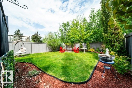 Expansive backyard featuring a manicured lawn, established perimeter landscaping, and a privacy fence - 8507 2 Avenue, Edmonton, AB - Outdoor With Backyard
