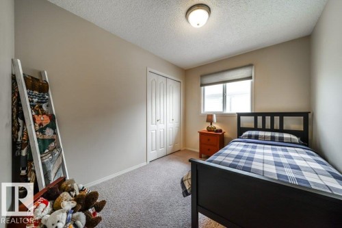 Neutral tone walls with textured ceiling and a single window featuring a roller shade - 8507 2 Avenue, Edmonton, AB - Indoor Photo Showing Bedroom