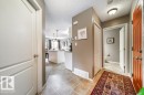 Entry foyer featuring tile flooring, a closet with bi-fold doors, and a flush-mount ceiling light fixture - 8507 2 Avenue, Edmonton, AB  - Indoor Photo Showing Other Room 