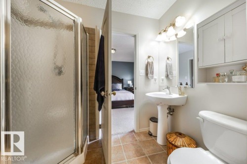 Bathroom featuring a pedestal sink, wall-mounted mirror, and overhead vanity lighting - 8507 2 Avenue, Edmonton, AB - Indoor Photo Showing Bathroom
