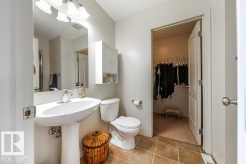 Pedestal sink with chrome faucet, wall-mounted mirror, and overhead vanity lighting - 8507 2 Avenue, Edmonton, AB - Indoor Photo Showing Bathroom