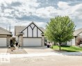 Gable-front exterior featuring decorative half-timbering and shingle siding - 71 Ridgehaven Crescent, Sherwood Park, AB 