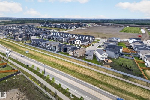 Modern suburban neighborhood featuring newly constructed residences and undeveloped land - 19286 22A Avenue, Edmonton, AB 