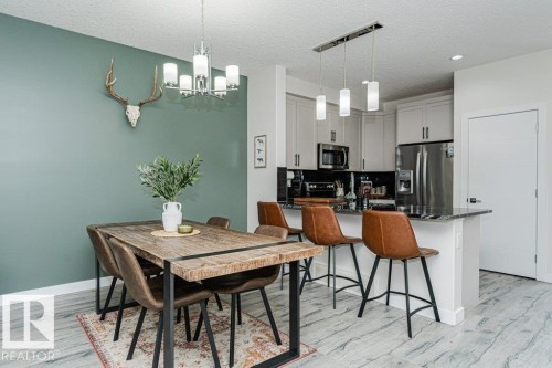 Open-concept living space with light wood-finish flooring - 721 Berg Loop, Leduc, AB - Indoor Photo Showing Dining Room