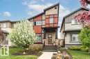 Contemporary exterior showcasing a multi-textured facade with vertical and horizontal siding, stone accents, and a prominent front entrance - 721 Berg Loop, Leduc, AB  - Outdoor With Facade 
