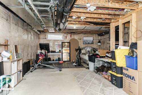 Unfinished basement featuring exposed ceiling joists and ductwork - 721 Berg Loop, Leduc, AB - Indoor Photo Showing Basement