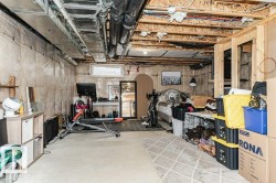 Unfinished basement featuring exposed ceiling joists and ductwork - 