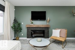Built-in fireplace featuring dark hexagonal tile surround and a rustic wood mantel - 